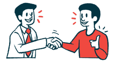 A patient gives a thumbs-up while shaking hands with a clinician.