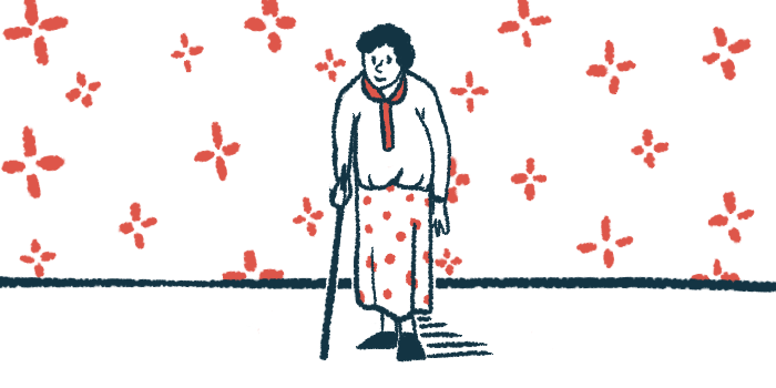 An elderly woman leans on a cane in a wallpapered room.